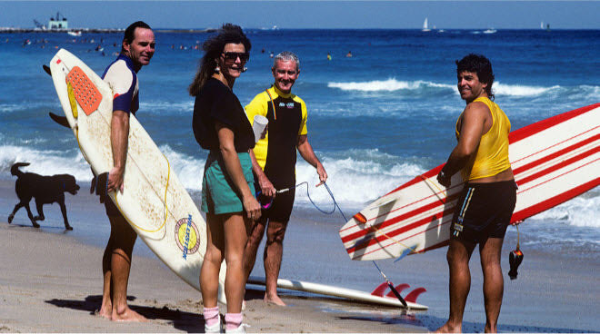 Palm Beach County surfers with their boards on the beach at Reef Road
